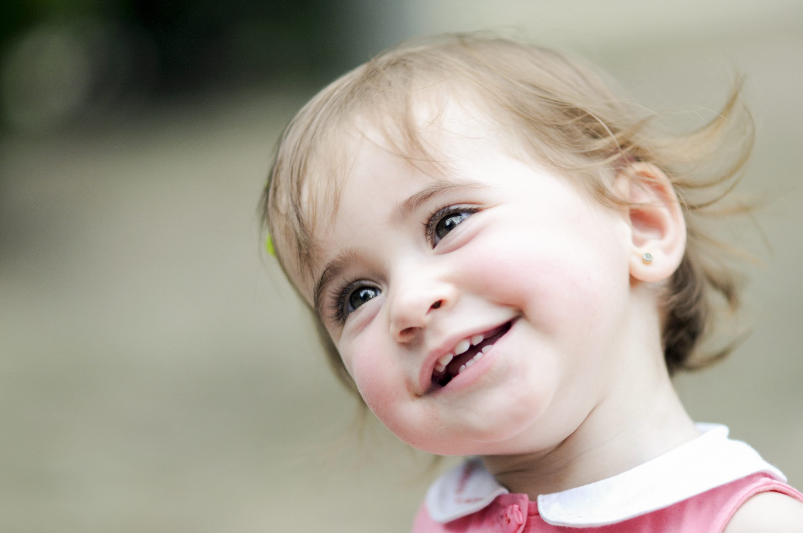 Adorable little girl playing in an urban park