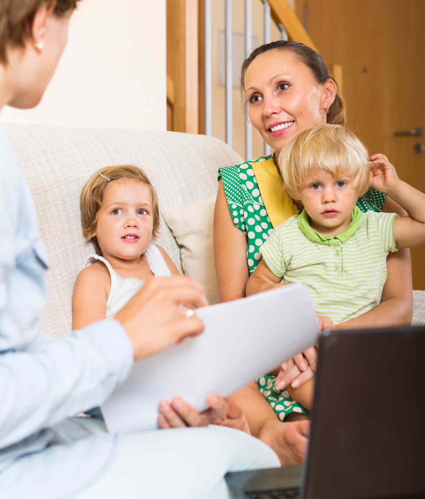 Dental team talking with a mother and her children