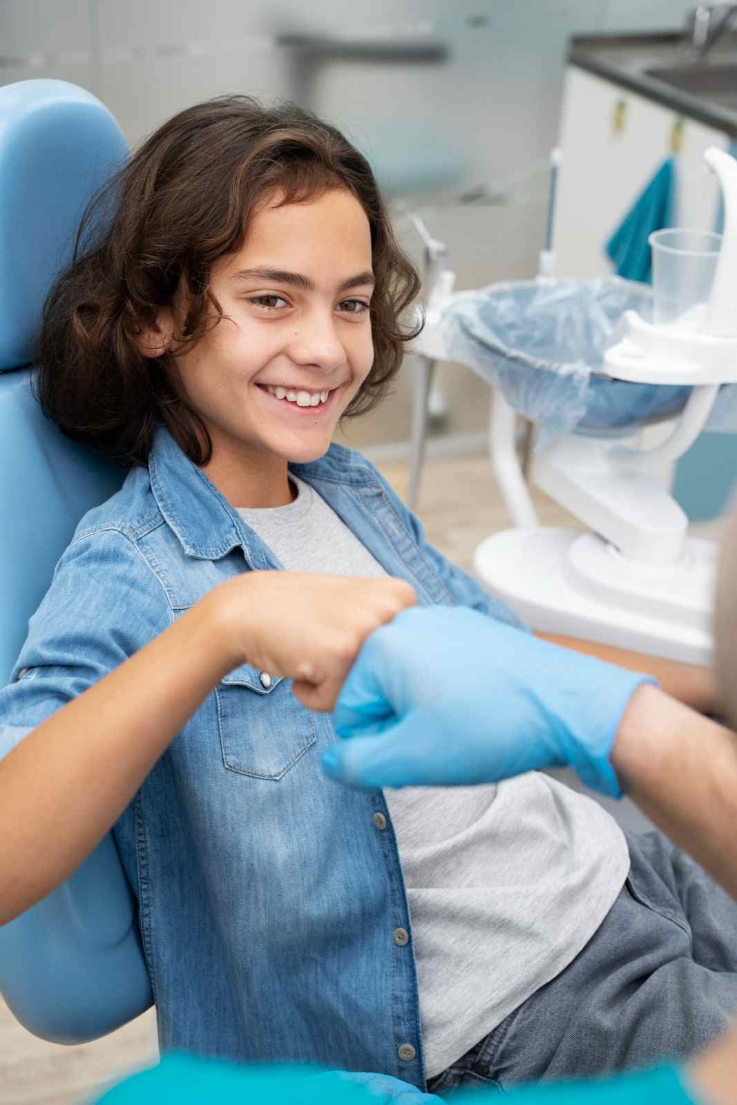 Boy smiling in dental chair, Sunshine KiDDS Dentistry