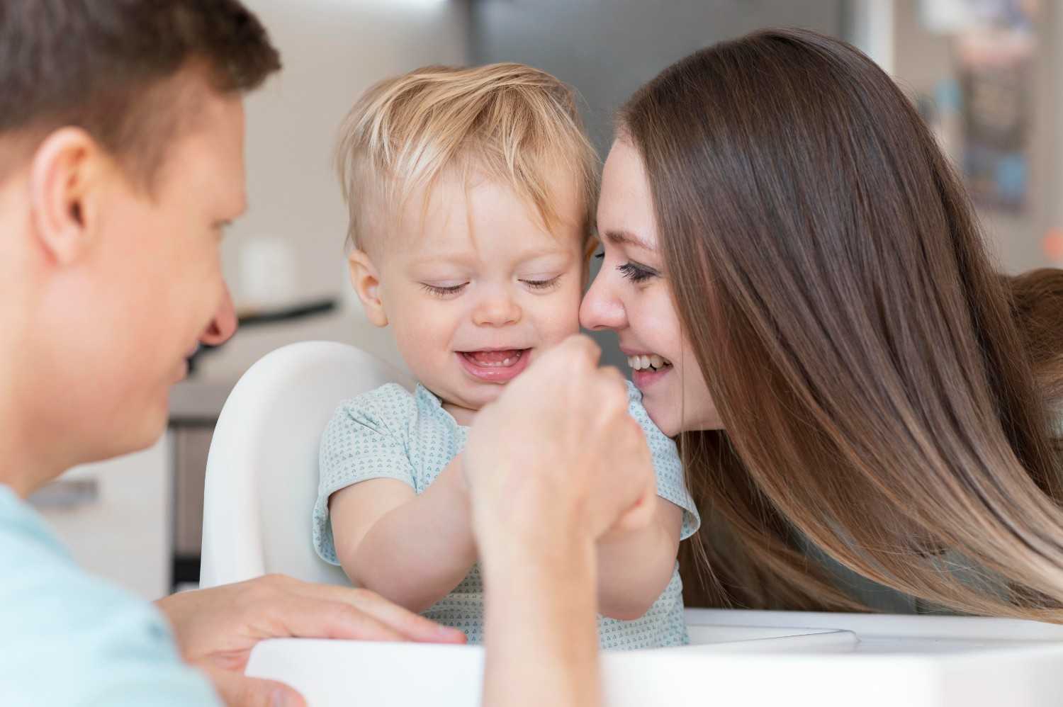 Parent gently caring for baby's gums before the first tooth appears