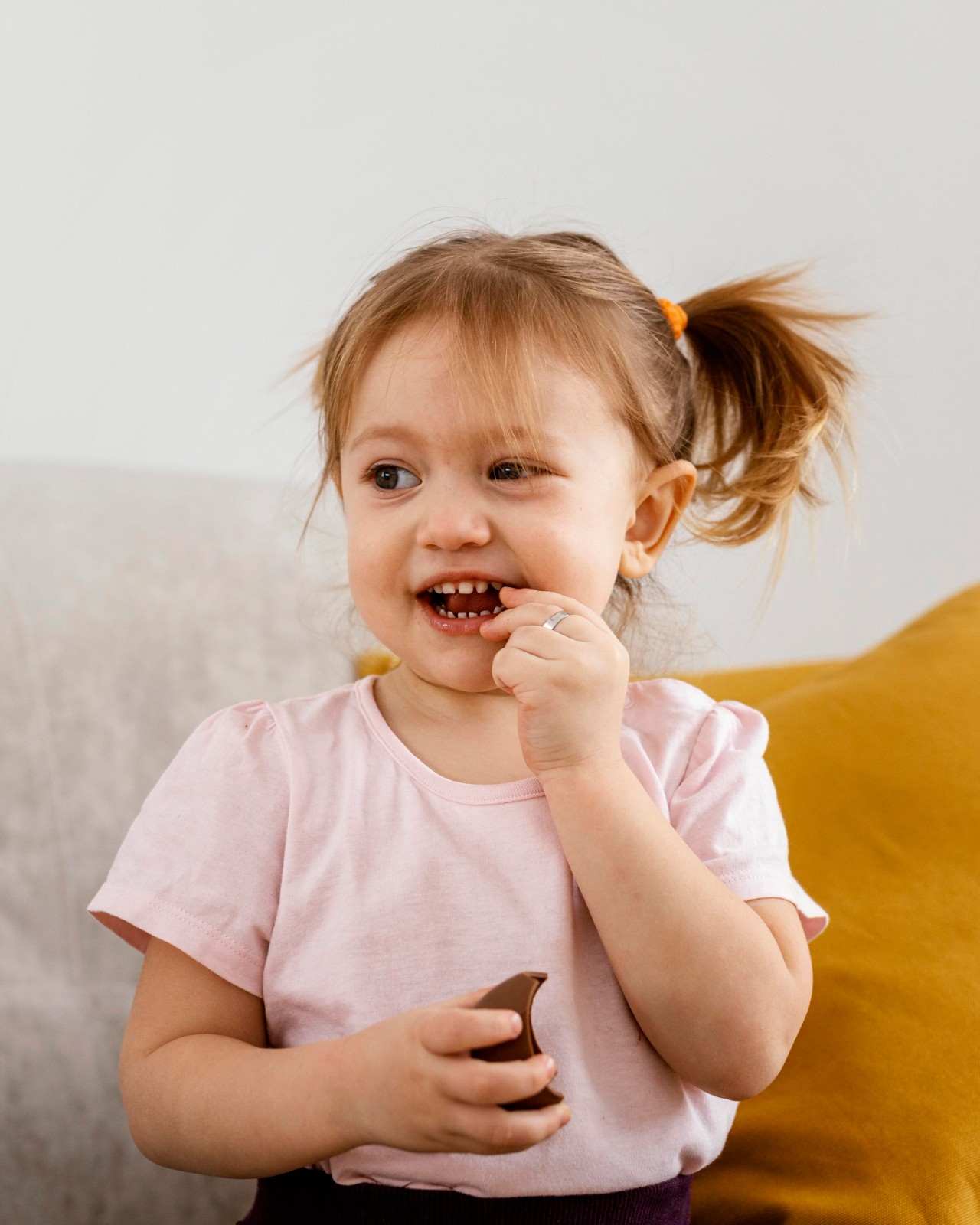 Toddler girl smiling at home