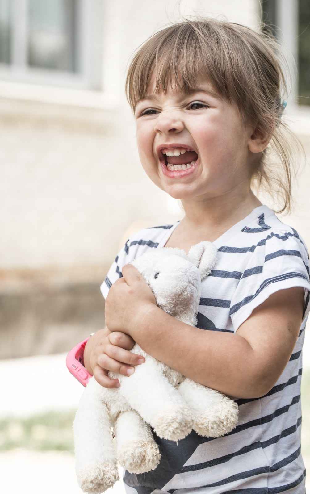 Little girl with a toy lamb, Sunshine KiDDS Dentistry