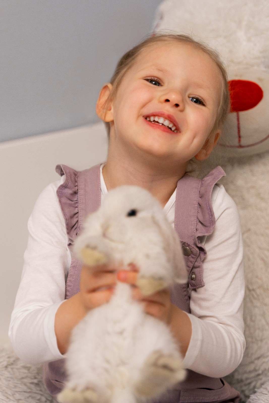 Girl playing with a toy bunny, Sunshine KiDDS Dentistry